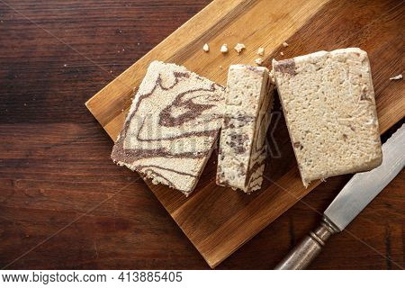 Halva Cocoa Slices On Wooden Table Background, Top View.