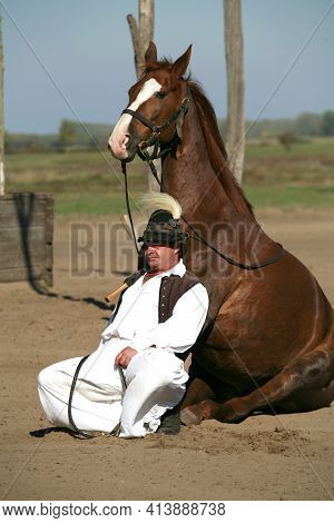 Puszta, Hungary, September, 04. 2020: Hungarian Herdsmen As Csikos In Traditional Folk Costume Showi