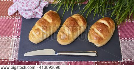 Delicious Golden Milk Bread Buns Handmade In The Traditional Style And In A Natural Way On A Gray Sl
