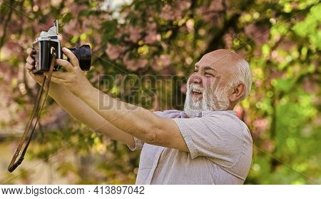 Memories In Snap. Everyone Photogenic. Senior Man Taking Selfie Photo Vintage Camera. Retro Equipmen