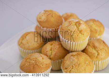Delicious Golden Muffins Covered With Freshly Baked Sugar On A White Square Plate On A White Backgro