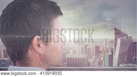 Spot of light over caucasian businessman against cityscape in background. global finance and business technology concept