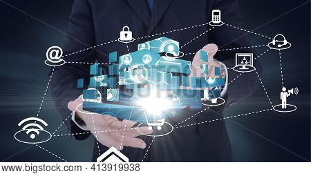 Composition of network of digital icons with glow over hands of businessman. global technology and digital interface concept digitally generated image.