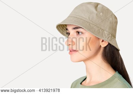 Beautiful woman in beige bucket hat fashion studio shoot