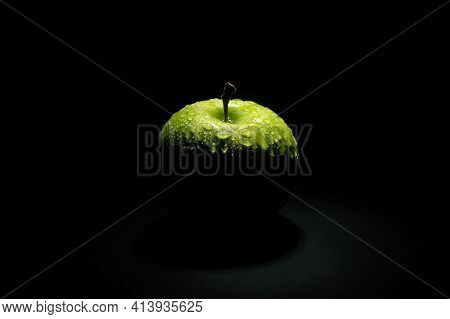 Fresh Green Apple With Water Drops Over Dark Background