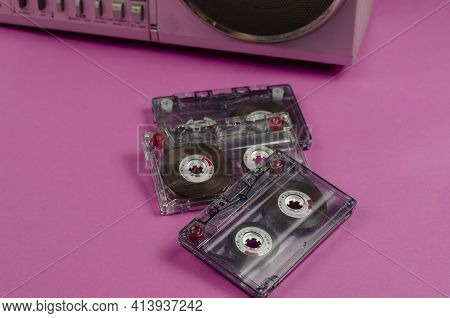 Boombox Stereo Radio Cassette Recorder And Random Cassettes On Pink Background. Vintage Cassette Dec