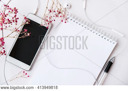Open Blank Notebook With Headphones Mobile Phone. Black Screen And Black Pen. Copy Space Foe Text. T