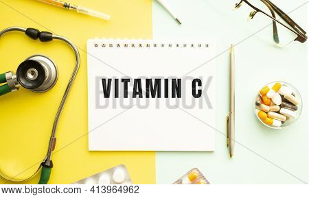 Text Vitamin C On Notebook With Stethoscope And Pen On Yellow Background. Medical Concept.