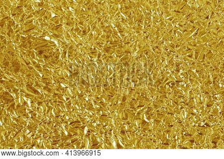Gold Foil Leaf Shiny Texture, Abstract Yellow Wrapping Paper For Background And Design Art Work.