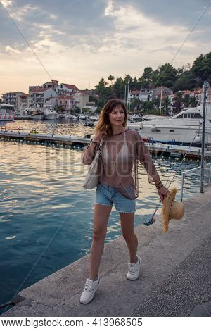 Joyful Woman Walking On The Embankment By The Sea On A Summer Evening