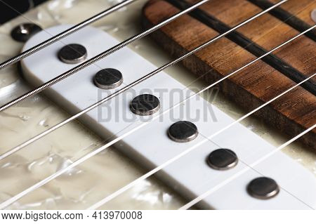 Guitar Fretboard With Tuning Pegs And Strings On A Gray Background. Close-up