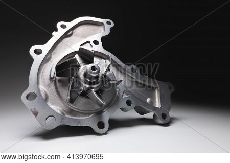 Water Pump Of The Internal Combustion Engine Cooling System. Contrasting On A Gray Gradient