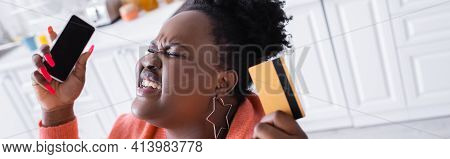 Stressed African American Plus Size Woman Holding Credit Card And Smartphone, Banner.