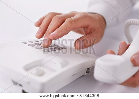 Man Making A Telephone Call On A Landline