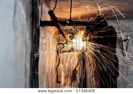 Professional Welder Cutting Metallic Pipes And Grinding Steel