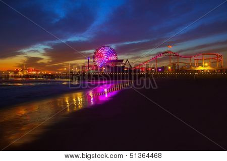 Santa Monica California sunset on Pier Ferrys wheel and reflection on beach wet sand