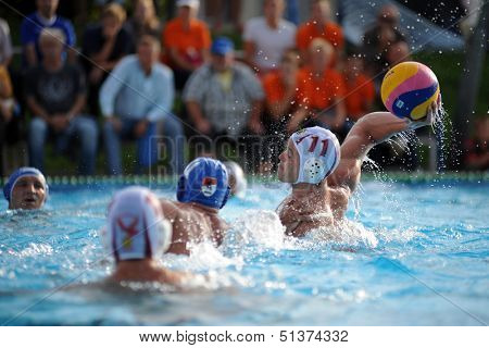 KAPOSVAR, HUNGARY - SEPTEMBER 15: Norbert Juhasz-Szelei (11) in action at a Hungarian championship water-polo game between Kaposvar (white) and Honved (blue) on September 15, 2013 in Kaposvar, Hungary