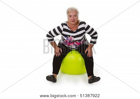 Female Senior Sitting On Swiss Ball