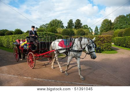 MOSCOW - SEPTEMBER 7: People ride in a carriage at Usadba Jazz Festival in Kuskovo Mansion on September 7, 2013 in Moscow. This festival was held on the Day of Moscow and was free to visit