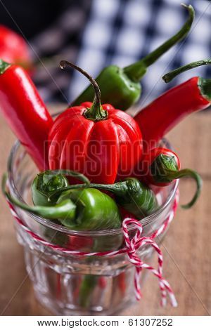 Red And Green Chili Peppers In Glass