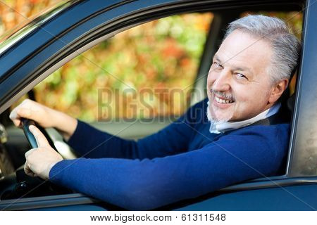 Mature man driving his car