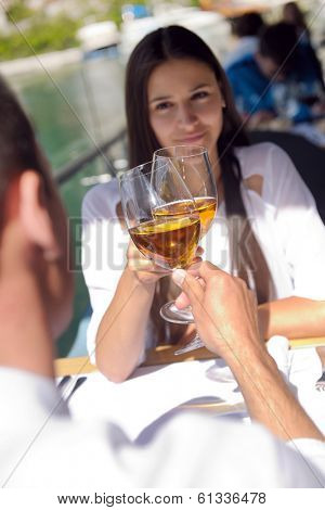 happy young couple having lanch at beautiful restaurant on the beach