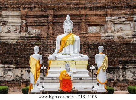Buddha Statues Against Ancient Pagoda At Wat Yai Chaimongkol