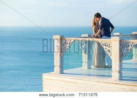 Couple Posing On A Balcony