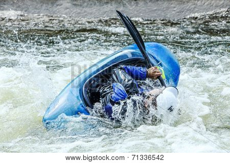 Kayak on whitewater. Focus on back of kayak and water 