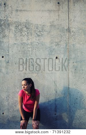 Sporty women taking break after evening run outdoors