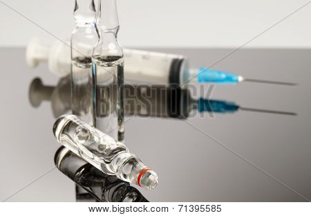 Ampules And Syringe Isolated On Black Background