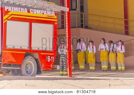 SAN PEDRO DE ATACAMA, CHILE, MAY 18, 2014: Fire brigade (mostly female) during a meeting in front of fire station 