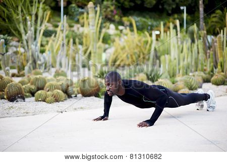 Athletic young man doing press ups before going for a run