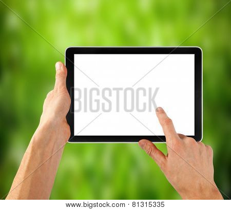 tablet ipades computer in hand on the winter forest backgrounds. 