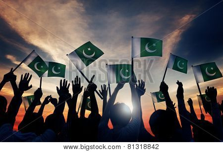 Group of People Waving Flag of Pakistan in Back Lit