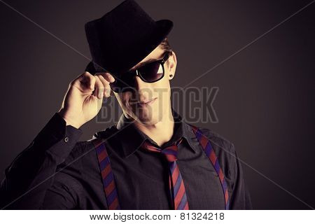 Portrait of an imposing young man in elegant clothes. Men's beauty, fashion.