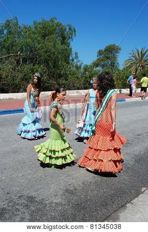 Spanish girls in flamenco dresses.