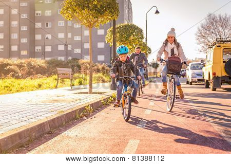 Family with child riding bicycles in the city