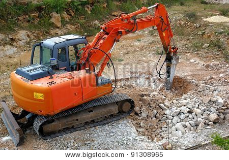 Large hydraulic Jackhammer Smashing Rocks