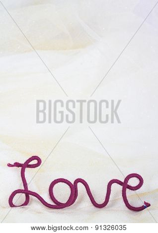 word love of red thread on fabric background