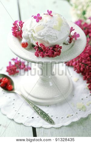 Beautiful composition with tasty ice cream and lilac flowers