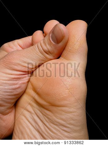 Thumb Pressure On Big Toe Massage On Dry Skin Isolated Towards Black