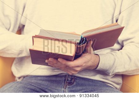 Young man reading book, close-up