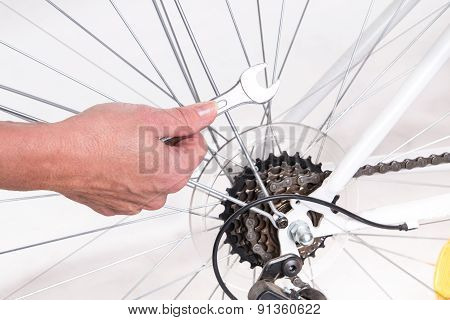 Woman Hand Repair Bicycle Whee With Screw Key