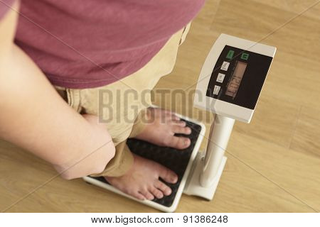 Man standing on digital scales cropped waist down