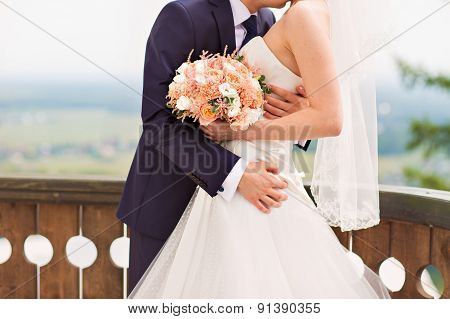Bride Holding Wedding Bouquet with beautiful Flowers