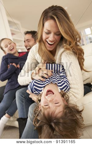 Parents playing with children at home