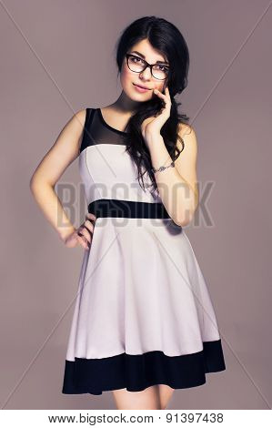 Beautiful Brunette Caucasian Business Woman In Classic Dress And Glasses. Neutral Grey Background