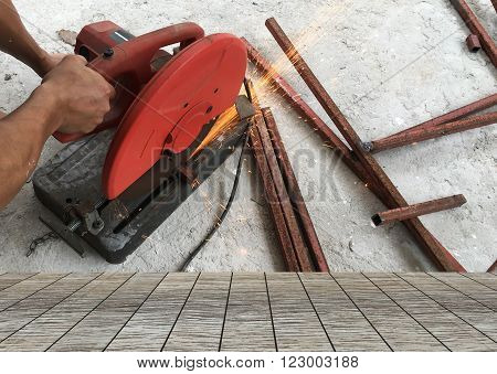 Man using steel cutters work and wood floor space for your product.