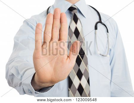 Male doctor holding up his hand in a Halt or Stop gesture